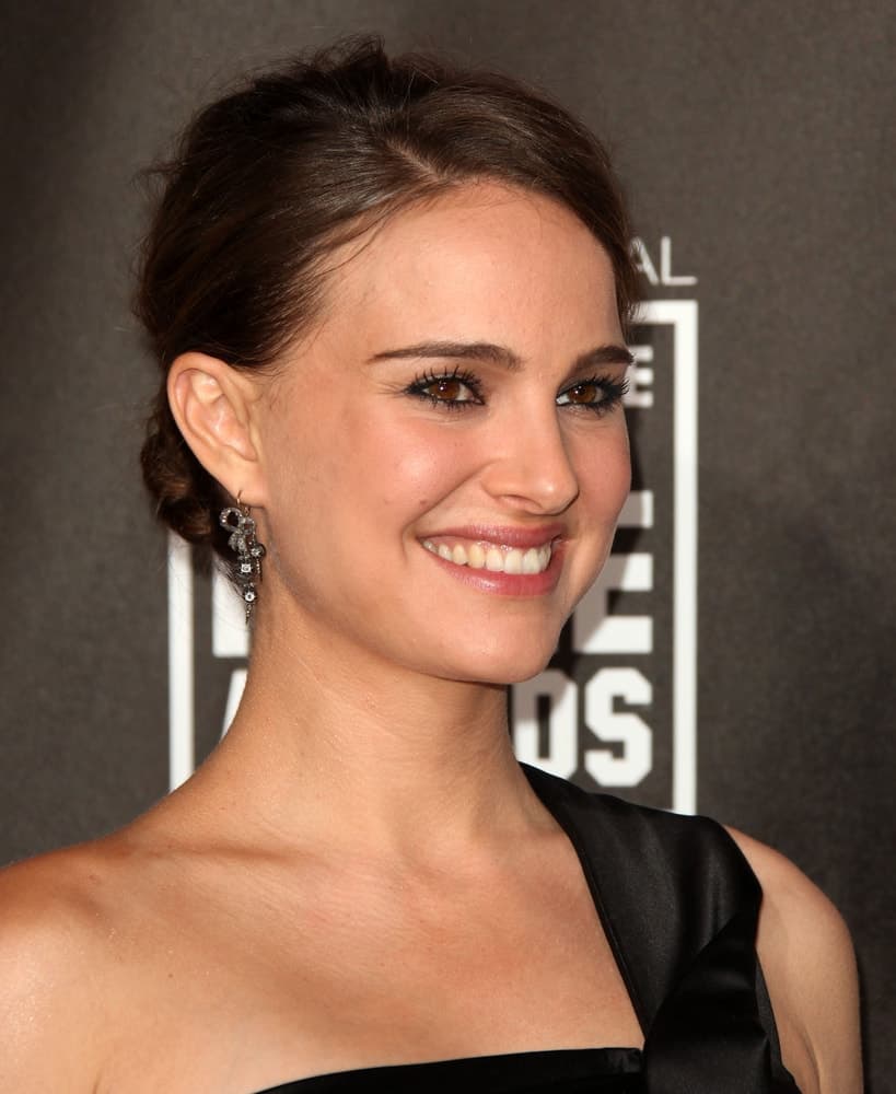 Natalie Portman arrived at the 16th Annual "Critics" Choice Movie Awards on January 14, 2011 in Los Angeles, CA wearing an elegant and stunning black dress to pair with her brilliant smile and loose low bun hairstyle.