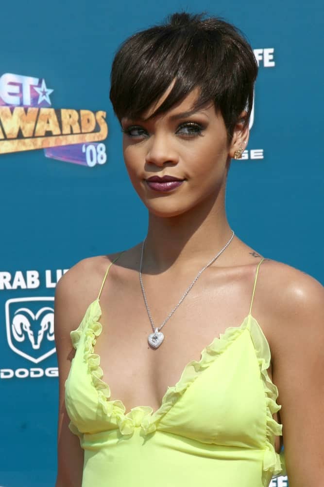 Rihanna was at the 2008 BET AWARDS held at the Shrine Auditorium in Los Angeles, CA on June 24, 2008. She paired her sunny yellow dress with some lovely make-up and a short side-swept raven pixie hairstyle.