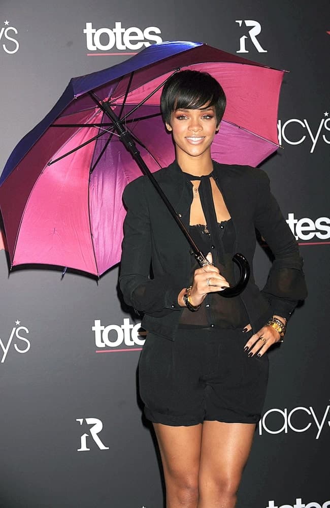 Rihanna wore a Matthew Williamson outfit at the Rihanna Umbrella Collection Launch by TOTES and MACY's held at the Macy's Herald Square Department Store in New York on February 05, 2008. She paired her black casual clothes with a simple pixie hairstyle with side-swept eye-skimmer bangs.