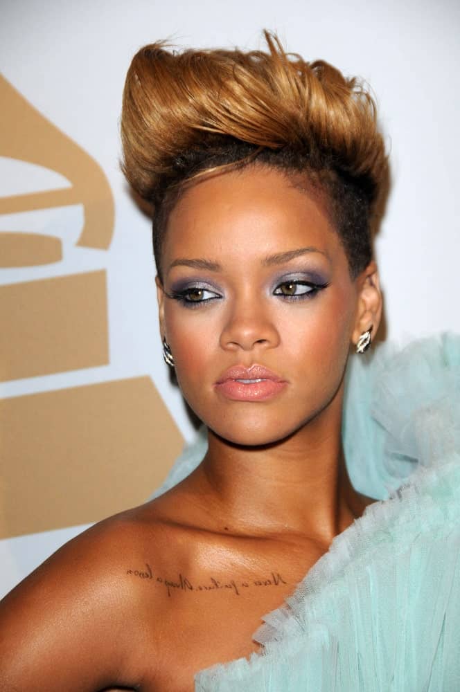 Rihanna wore a charming blue dress to pair with her edgy undercut pixie hair with highlights and a spiked pompadour finish at The Recording Academy and Clive Davis Present The 2010 Pre-Grammy Gala - Salute To Icons held at the Beverly Hilton Hotel in Beverly Hills, CA on January 30, 2010.