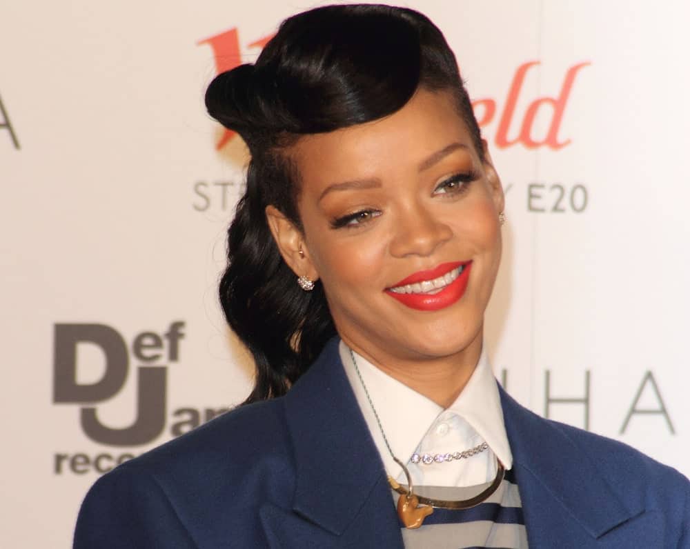 Rihanna wore a smart casual outfit with her ponytail hairstyle incorporated with side-swept bangs when she attended the Westfield Stratford City Christmas Lights Lighting Ceremony in Stratford, London on November 19, 2012.