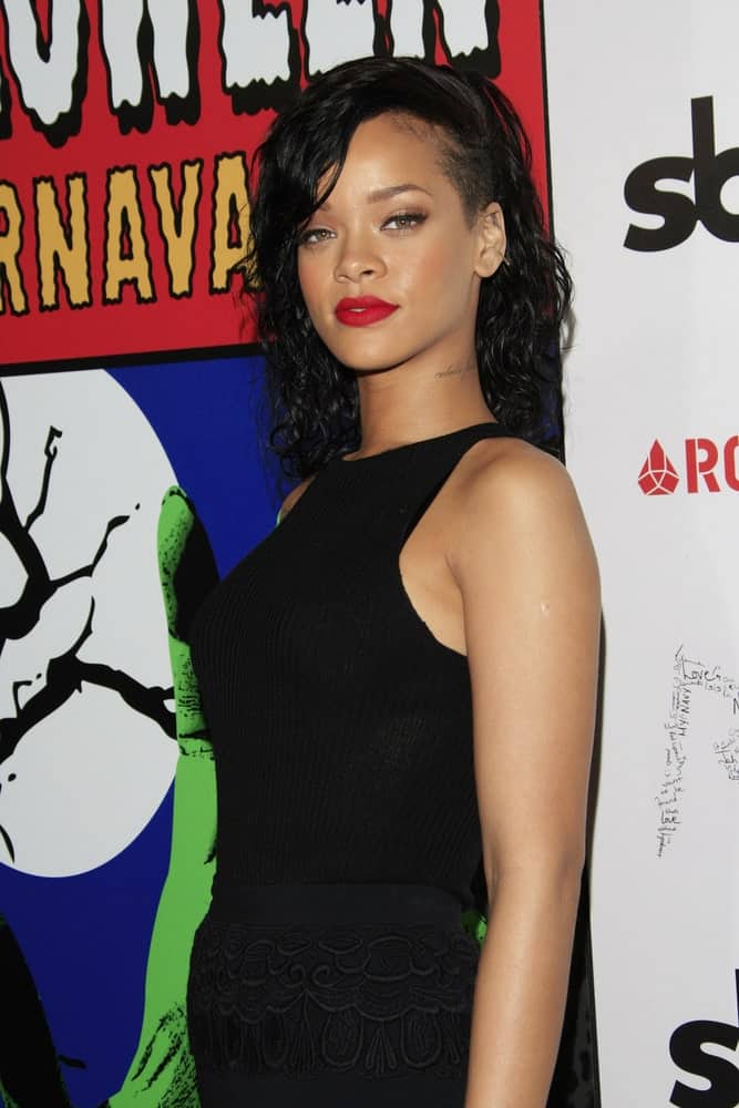 Rihanna was named the Queen of the 2012 West Hollywood Halloween Carneval at Greystone Manor Supperclub on October 31, 2012 in West Hollywood, California. She wore a black casual ensemble outfit with her shoulder-length raven curly hair with a shaved side.