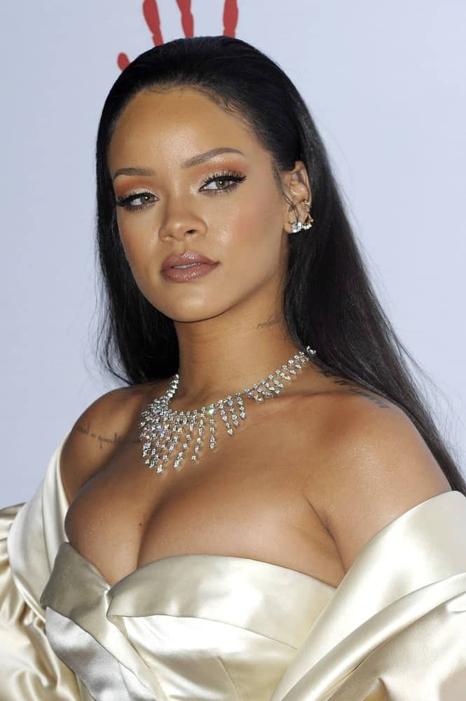 Rihanna wowed everyone with her stunning pearly white dress and slicked back long straight hairstyle at the 2nd Annual Diamond Ball held at the Barker Hanger in Santa Monica, USA on December 10, 2015.