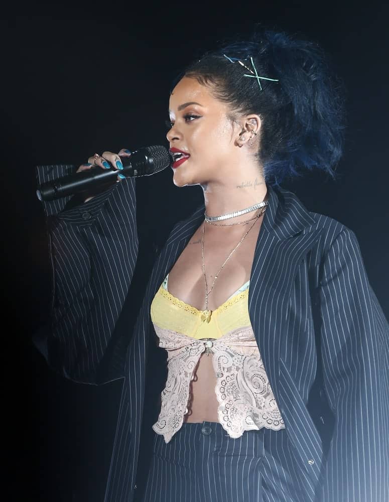 Recording artist Rihanna performed onstage during the CBS RADIO Third Annual "We Can Survive" event, presented by Chrysler at the Hollywood Bowl on October 24, 2015 in Hollywood, California. She performed wearing a pinstriped suit with her high ponytail that has curly tips.