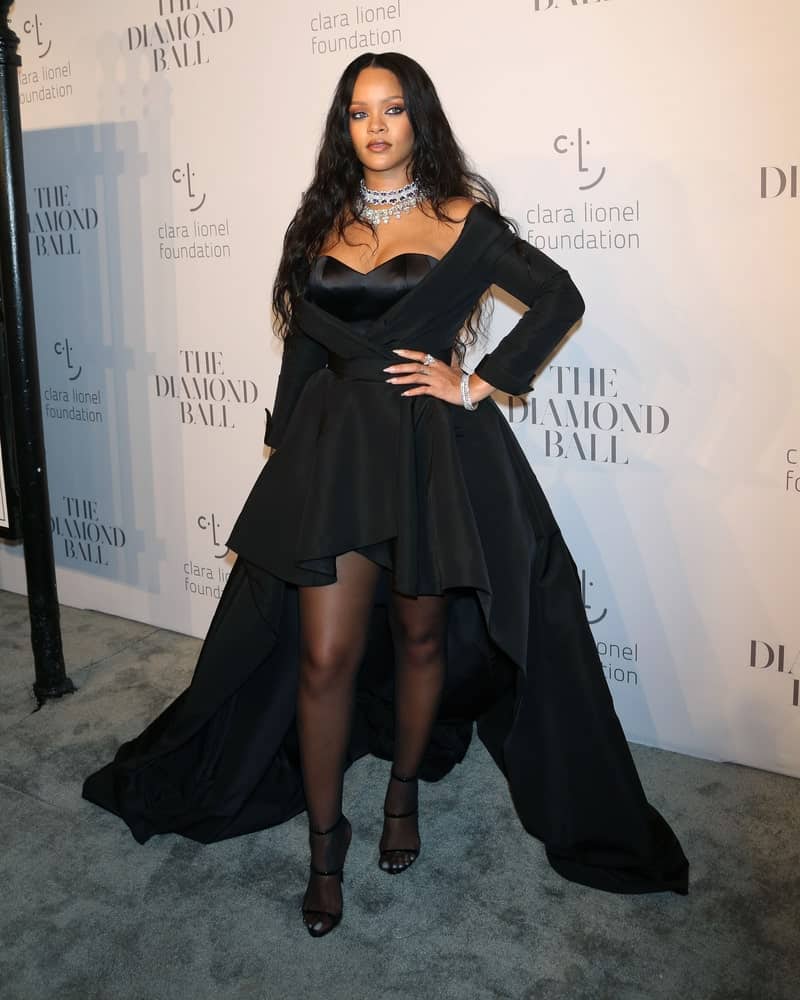Rihanna went with a slight goth look in her pure black outfit and long tousled wavy raven hairstyle when she attended the 3rd annual Diamond Ball at Cipriani on September 14, 2017, in New York City.