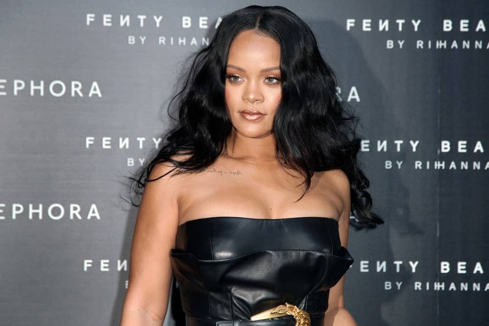 Rihanna matched her black leather sexy dress with her thick raven long hair that has a tousled wavy finish at the Sephora Fenty Beauty by Rihanna launch event on April 5, 2018 in Milan, Italy.