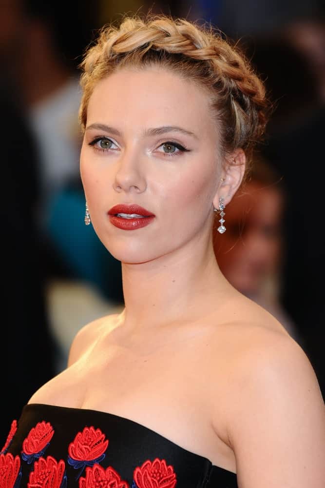 Scarlett Johansson wore a black dress that has red roses embroidered on it to pair with her beautiful crown braid upstyle for the "Avengers Assemble" premiere at the Vue cinema Westfield in London on April 19, 2012.