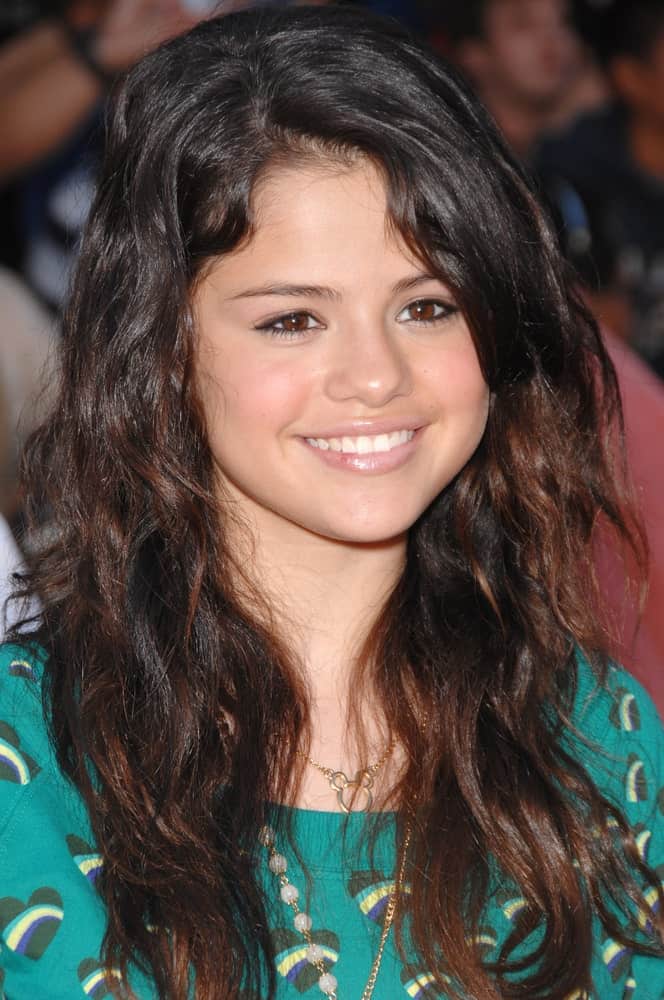 Selena Gomez was at the world premiere of "The Game Plan" at the El Capitan Theatre, Hollywood on September 23, 2007. She wore a casual patterned shirt that she paired with a long, wavy and tousled hairstyle with highlights.