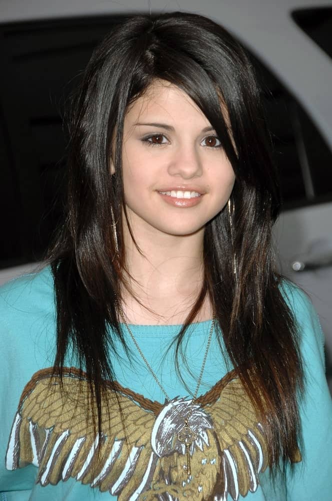 Selena Gomez wore a simple cool shirt with her straight and layered hairstyle that has highlights at the CHEVY ROCKS THE FUTURE Environmentally-Friendly Car Showcase at The Walt Disney Studios in Burbank, CA on February 19, 2008.