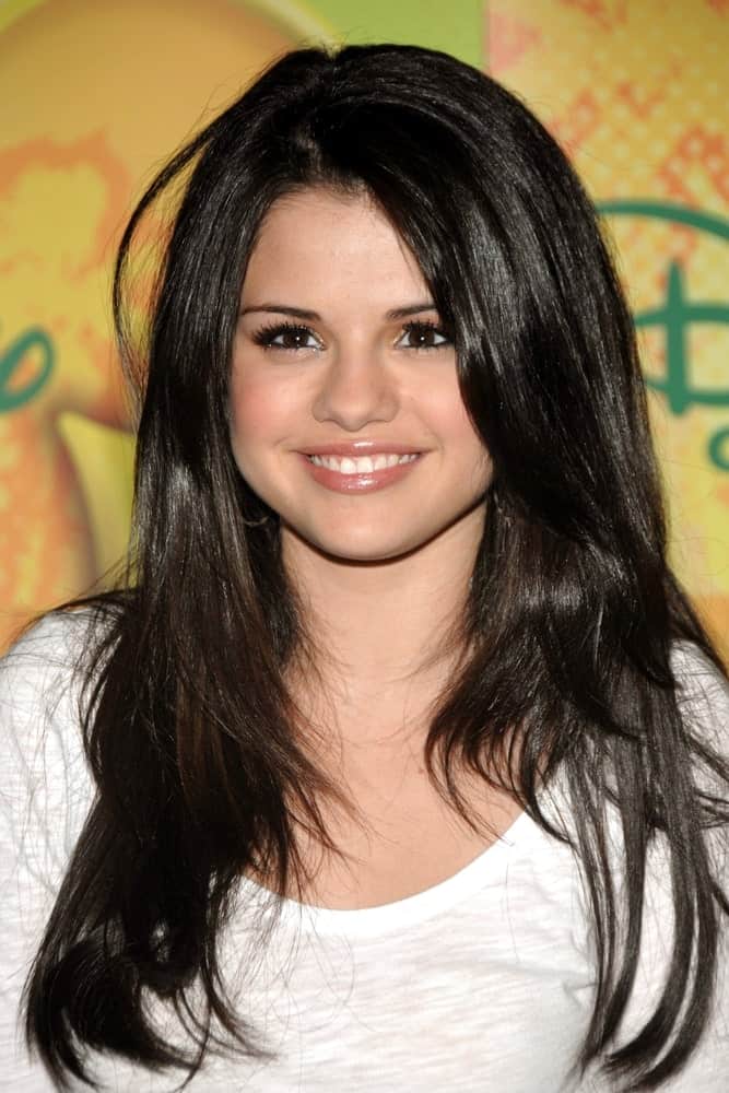 Selena Gomez attended the press conference for New York Times Talks with WIZARDS OF WAVERLY PLACE at The Times Center in New York on September 06, 2008. She wore a simple white shirt with her long and layered raven hairstyle.