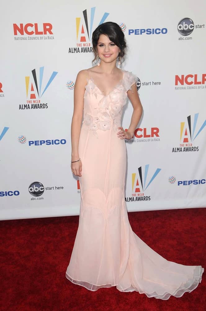 Selena Gomez looked absoluetly gorgeous in her long light pink dress with frills to pair with her messy and loose bun hairstyle with loose curtain bangs at the 2009 ALMA Awards held at the Royce Hall UCLA, Westwood on September 17, 2009.