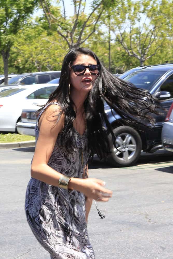 Selena Gomez was seen walking to the parking lot of Commons Shopping Center in Calabasas, California on May 27, 2012. She wore a long casual dress that she paired with her long and loose wavy hairstyle.