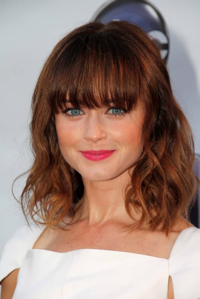 Alexis Bledel was at the "Remember Sunday" Red Carpet Premiere Event at the Fox Studios on April 17, 2013 in Century City, CA. SHe wore a white dress with her shoulder-length curly brunette hairstyle that ha blunt eye-skimmer bangs.