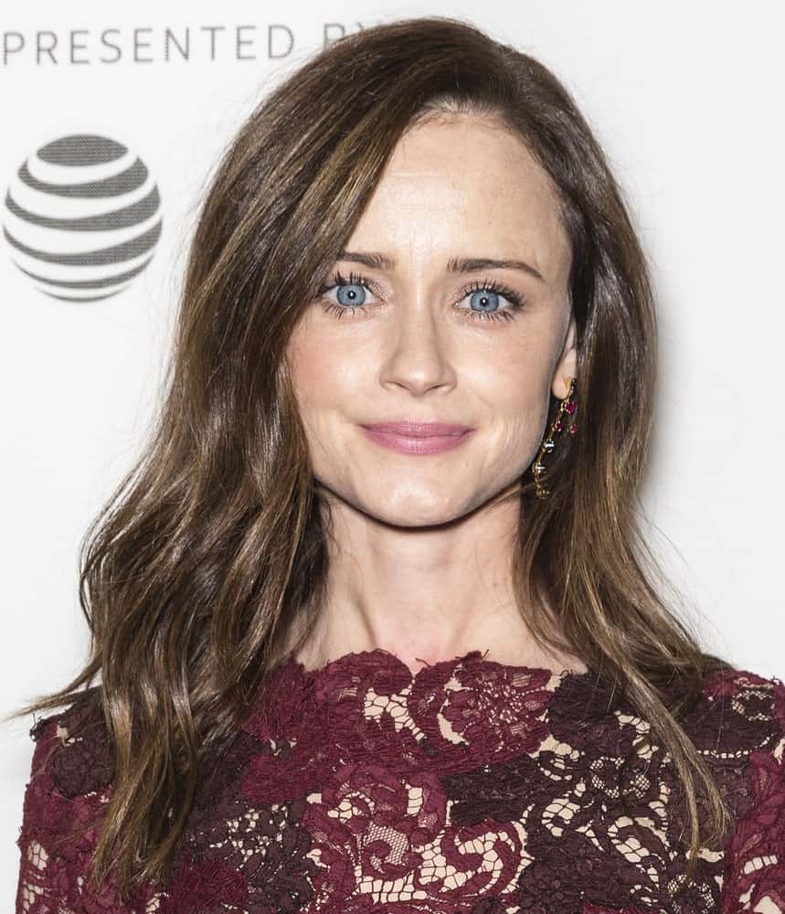 On April 21, 2017, actress Alexis Bledel attended the premiere of 'The Handmaid's Tale' during Tribeca Film Festival at BMCC Tribeca PAC. She wore a lovely embroidered purple dress with her long dark brunette hairstyle that has layers, waves and a slight tousle.