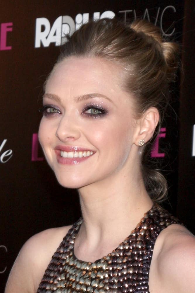 Amanda Seyfried flashed her brilliant and beautiful smile with her sexy dress and high bun hairstyle that has a slightly tousled look with loose tendrils at the "Lovelace" LA Premiere at the Egyptian Theater on August 5, 2013 in Los Angeles, CA.