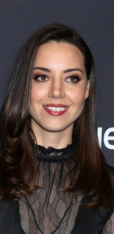 Aubrey Plaza was at the PaleyFest - "Parks and Recreation" 10th Anniversary Reunion at the Dolby Theater on March 21, 2019 in Los Angeles, CA. She was sexy and stunning in a black sheer dress that she paired with her long and loose tousled raven hairstyle with layers and long side bangs.