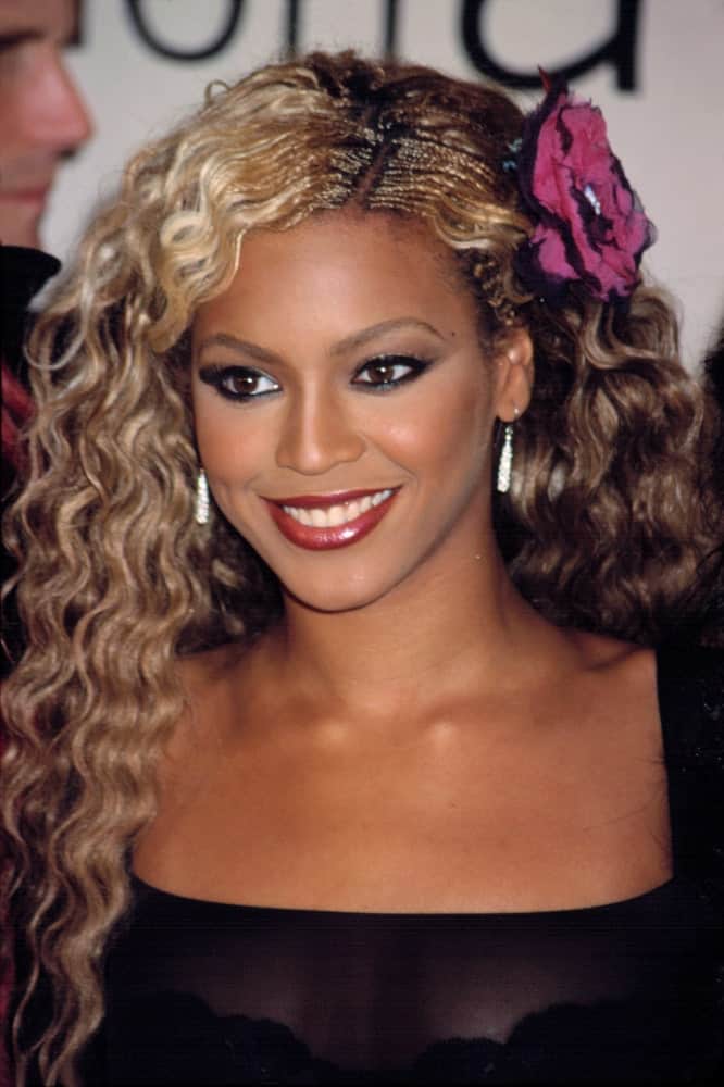 Beyonce exhibited her blonde highlighted curls that are side pinned with a flower during the VH1/ Vogue Fashion Awards in New York on October 19, 2001.