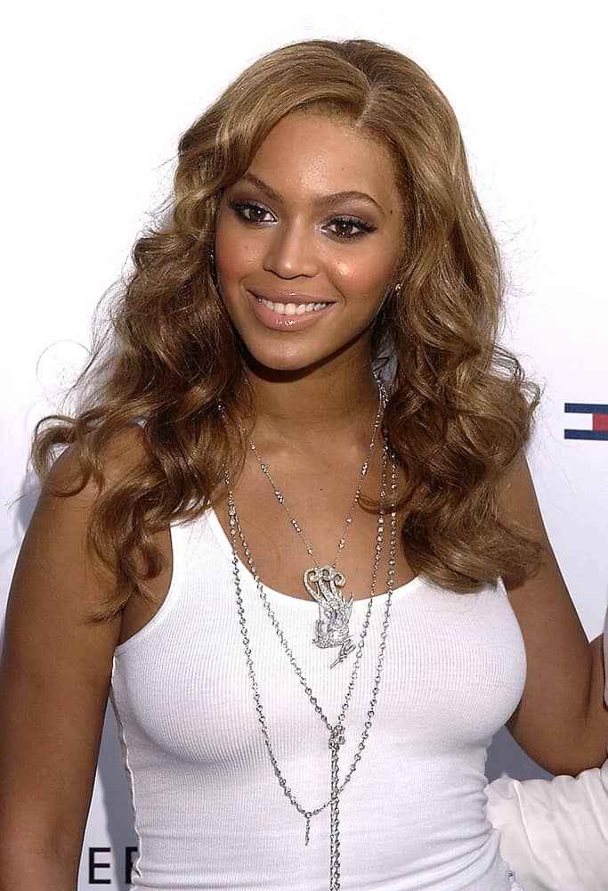 Beyonce Knowles in a casual white top tank paired with her side-parted curls at the launch of her new fragrance A TRUE STAR at the Chelsea Art Museum, NY held on June 24, 2004.