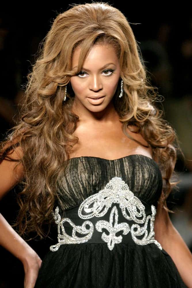 Beyonce incorporates her slicked-back waves with long curtain bangs at the Fashion For Relief at Bryant Park, New York, NY held on September 16, 2005.