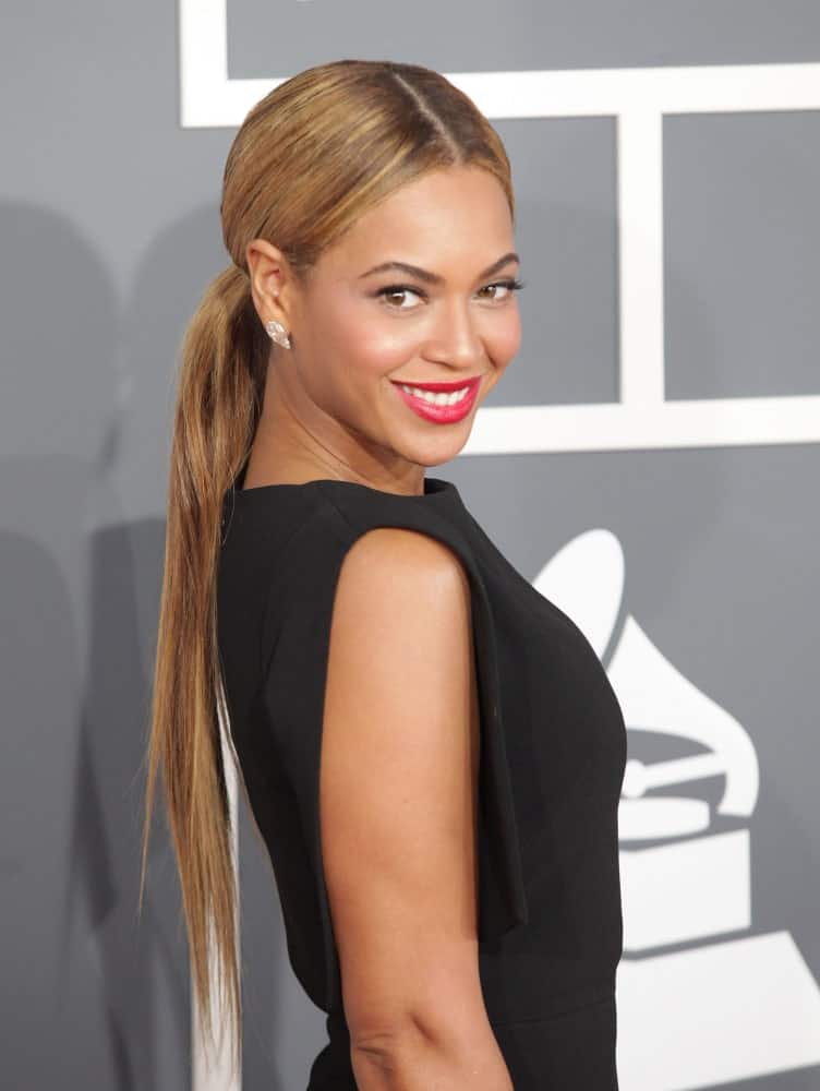 Beyonce Knowles went for a low ponytail with middle parting during the 2013 Grammy Awards on February 10, 2013, in Hollywood, CA. She finished the look with red lipstick and a classic black dress.