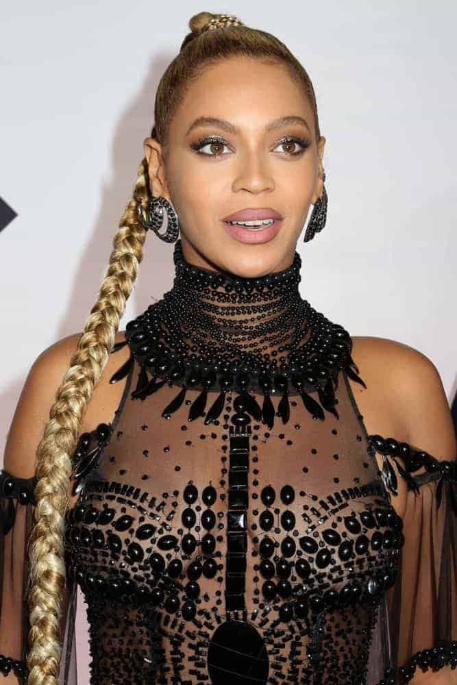 Beyonce Knowles is an epitome of fierce and sultry in her sheer beaded gown and an ultra long slicked back braided ponytail hairstyle as she attends the TIDAL X: 1015 concert at the Barclays Center.