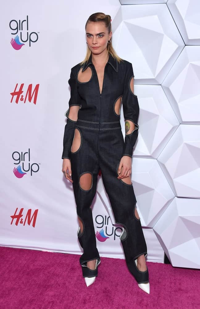 Cara Delevingne wore a fashion-forward denim jumpsuit with her slick highlighted half-up hairstyle when she arrived at the 2nd Annual Girl Up #GirlHero Awards on October 13, 2019 in Beverly Hills, CA.