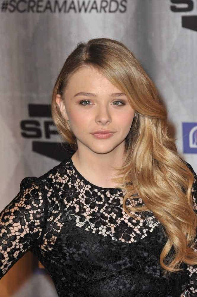 Chloe Grace Moretz was at the 2011 Spike TV Scream Awards at Universal Studios, Hollywood on October 15, 2011. She was charming in a black sheer dress that went perfectly well with her long and wavy side-swept hairstyle with layers and highlights.