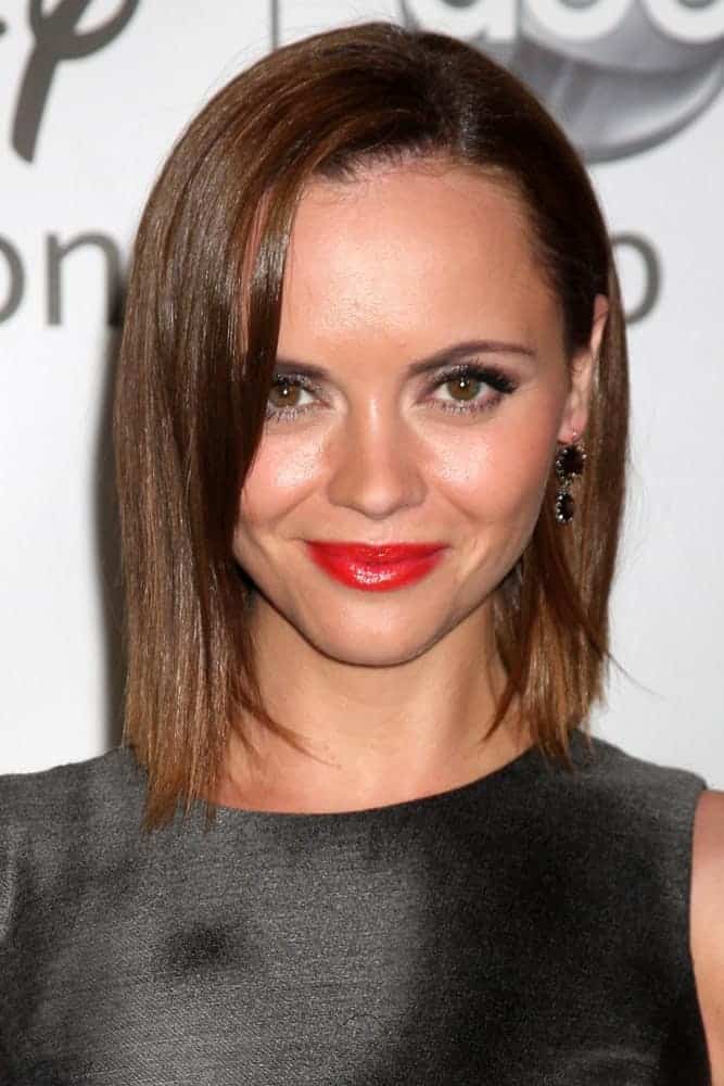 Christina Ricci was at the Disney / ABC Television Group 2011 Summer Press Tour Party at Beverly Hilton Hotel on August 7, 2011, in Beverly Hills, CA. She wore a black dress with her red lips and chin-length brunette bob hairstyle with a silky straight finish.