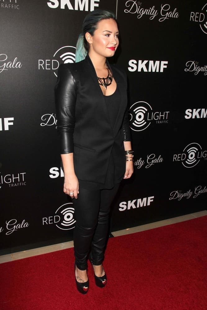 Demi Lovato's red lips paired quite well with her black leather outfit and tight ponytail with blue highlights at the Dignity Gala and Launch of Redlight Traffic App at Beverly Hilton Hotel on October 18, 2013 in Beverly Hills, CA.