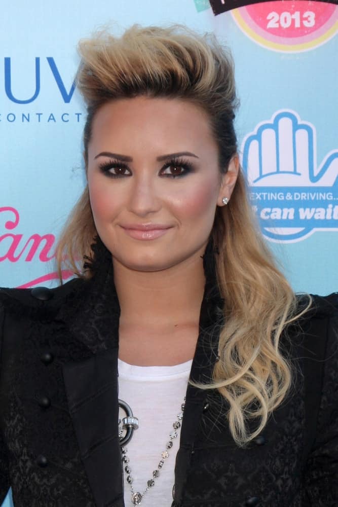 Demi Lovato went with a vintage 80's half-up hairstyle with a tall tousle up top and blond highlights at the 2013 Teen Choice Awards at the Gibson Ampitheater Universal on August 11, 2013 in Los Angeles, CA.
