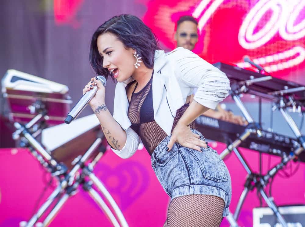 Recording artist Demi Lovato performed onstage at the 2015 iHeartRadio Music Festival at the Las Vegas Village on September 19, 2015 in Las Vegas, Nevada. She paired her sexy outfit with a side-swept and tousled short raven hairstyle with subtle highlights.