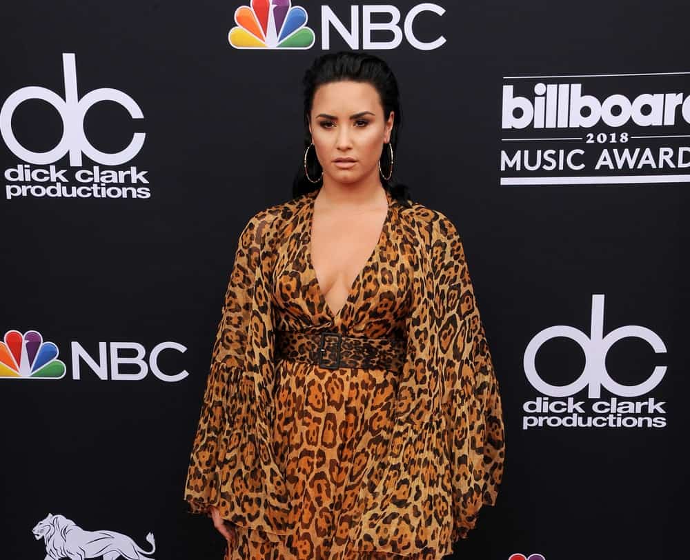 Demi Lovato wore an animal print dress with her slicked back raven hairstyle at the 2018 Billboard Music Awards held at the MGM Grand Garden Arena in Las Vegas, USA on May 20, 2018.
