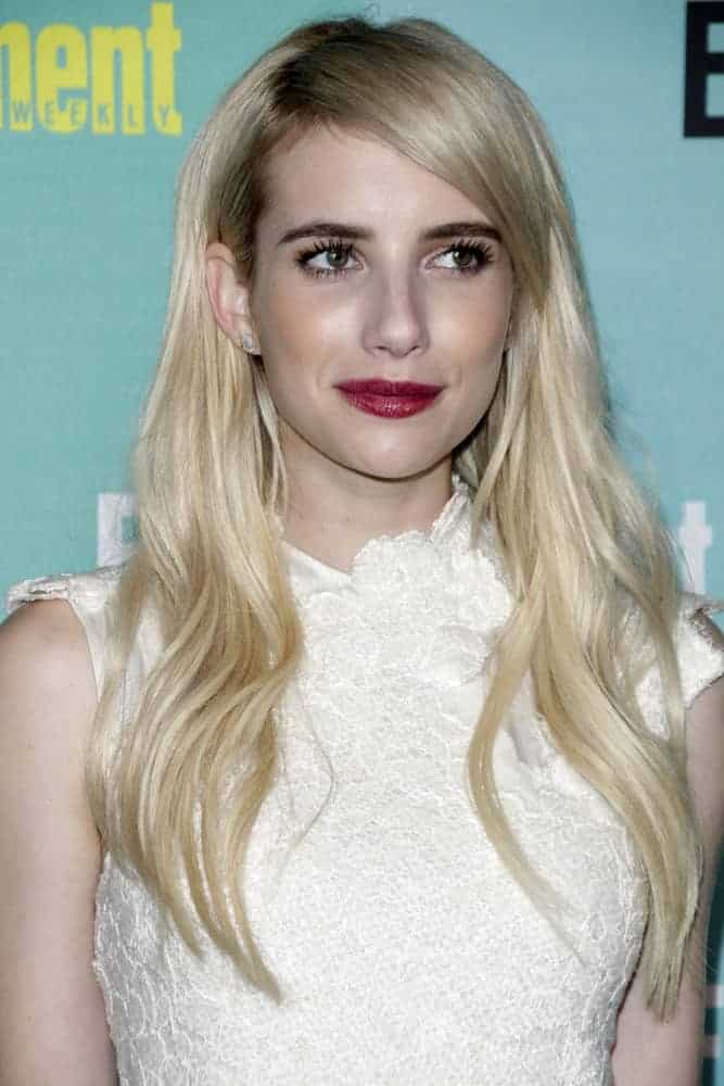 Emma Roberts attended the Entertainment Weekly's Annual Comic-Con Party at the FLOAT at The Hard Rock Hotel on July 11, 2015 in San Diego, CA. She paired her charming white dress with a long and tousled loose blonde hairstyle with side-swept bangs.