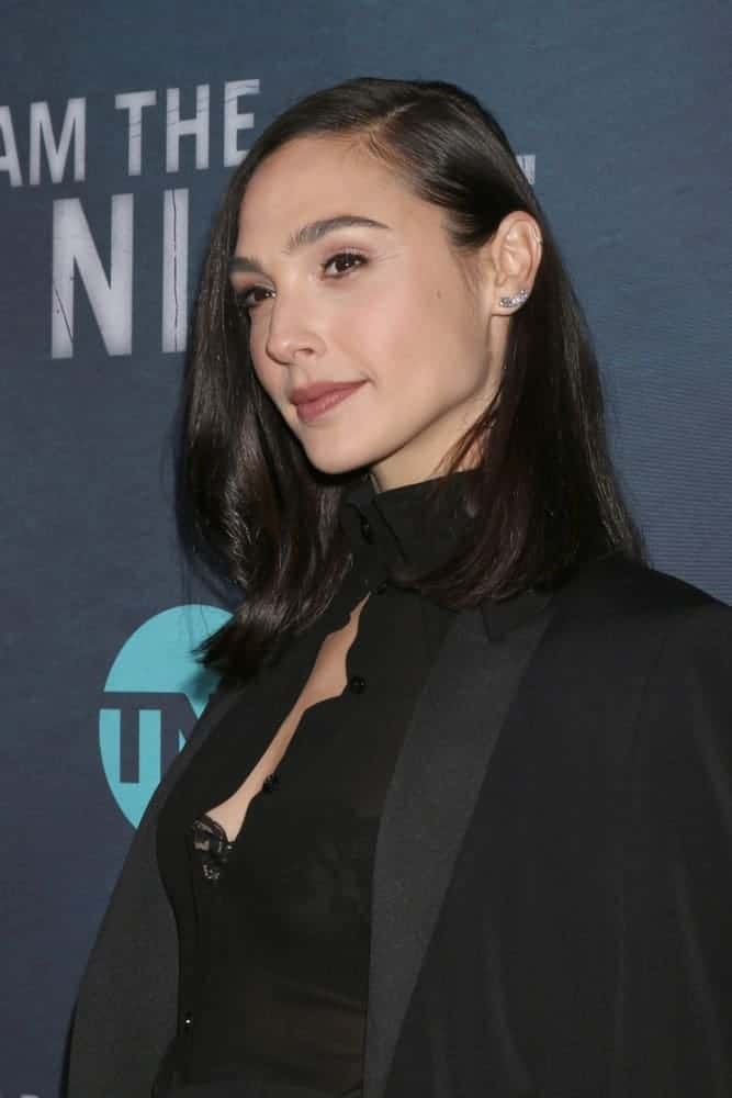 Gal Gadot attended the "I Am The Night" Premiere Screening at the Harmony Gold Theater on January 24, 2019, in Los Angeles, CA. She wore an all-black outfit to pair with her shoulder-length side-swept raven hairstyle with waves at the tips.