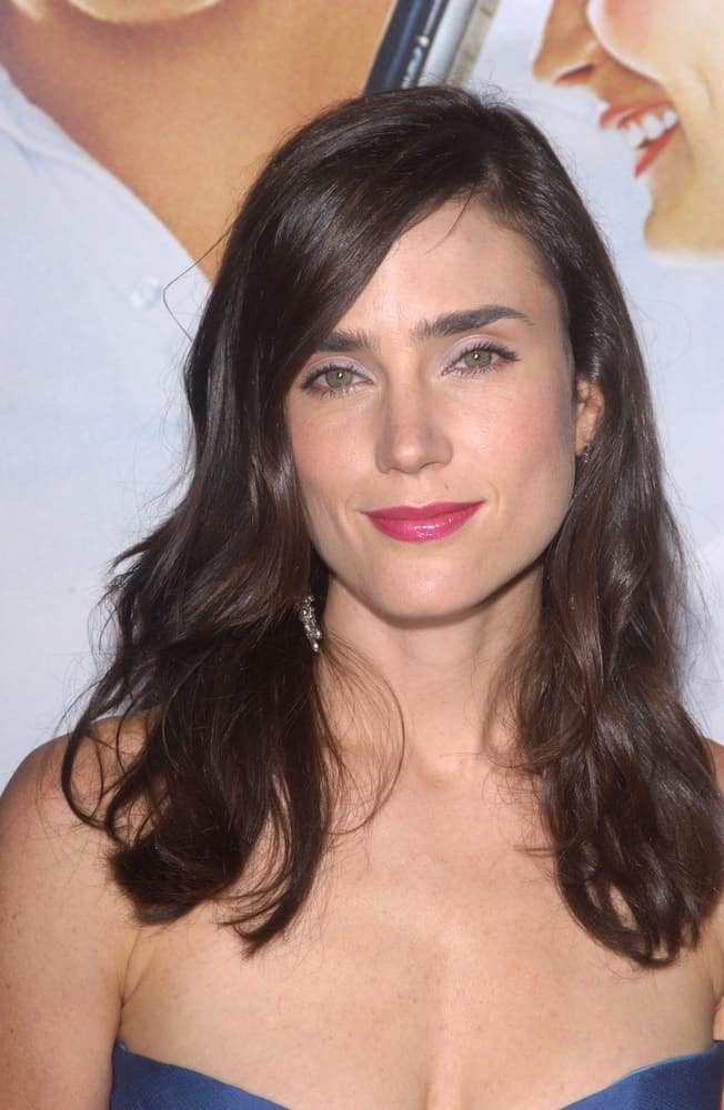 Actress Jennifer Connelly attended the world premiere, in Beverly Hills, of the new tennis romantic comedy Wimbledon on September 13, 2004. She paired her sexy strapless dress with a medium-length tousled and wavy dark layered hairstyle with side-swept bangs.