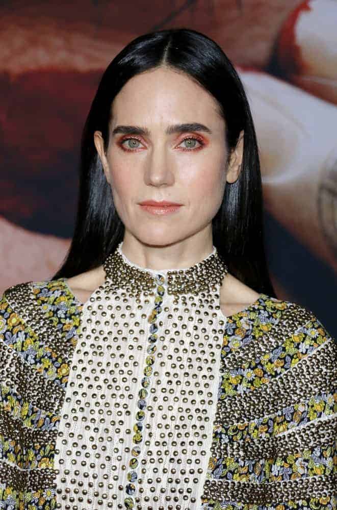 Jennifer Connelly attended the Los Angeles premiere of 'Alita: Battle Angel' held at the Regency Village Theatre in Westwood on February 5, 2019. She paired her detailed dress with a long and silky straight raven hairstyle parted in the middle.
