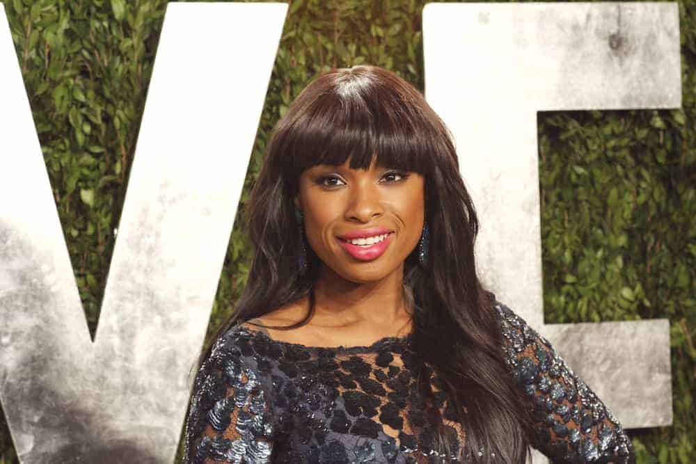 Jennifer Hudson attended the Vanity Fair Oscar Party at Sunset Tower on February 24, 2013 in West Hollywood, California. She was stunning in a black dress that she topped with a long, loose and tousled dark hairstyle with blunt bangs.