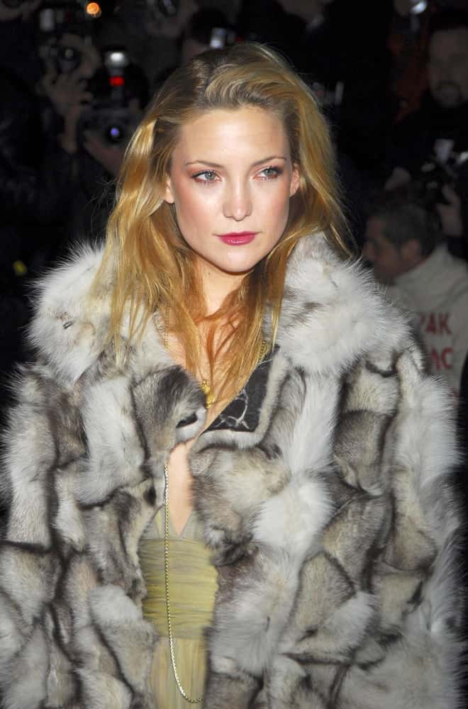 Kate Hudson was at the Versace Fifth Avenue Re-Opening Party, Versace Fifth Avenue Boutique in New York, NY on February 07, 2006. She wore a fashionable fur coat that she paired with a loose and tousled side-swept sandy blond hairstyle with highlights.