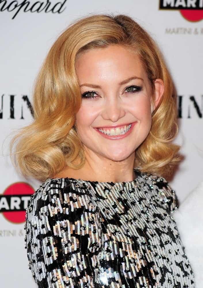 Kate Hudson went with a vintage look to her side-swept shoulder-length sandy blond hairstyle with curls at the tips at the New York Premiere of NINE held at The Ziegfeld Theatre in New York, NY on December 15, 2009.