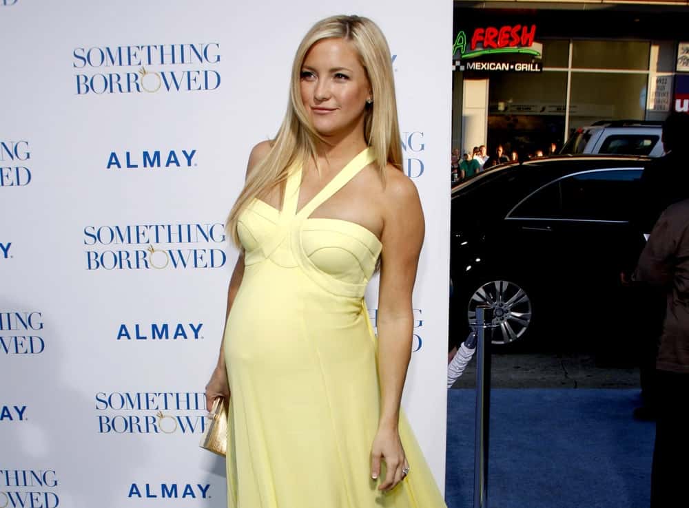 Kate Hudson had that pregnant glow that she complemented with a yellow dress and a loose layered straight blond hairstyle with side-swept bangs at the Los Angeles Premiere of "Something Borrowed" held at the Grauman's Chinese Theater in Los Angeles, California, United States on May 3, 2011.