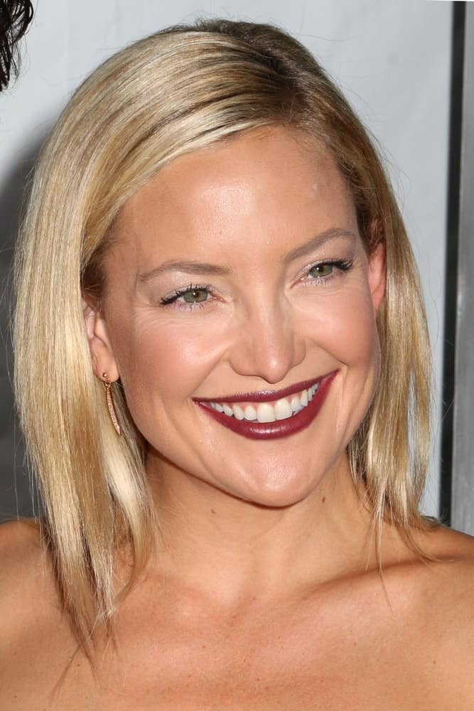 Kate Hudson's bold dark lipstick went quite well with her black leather dress and straight blond hairstyle with a side-swept finish at the premiere of "Wish I Was Here" at the AMC Lincoln Square Theater on July 14, 2014 in New York City.