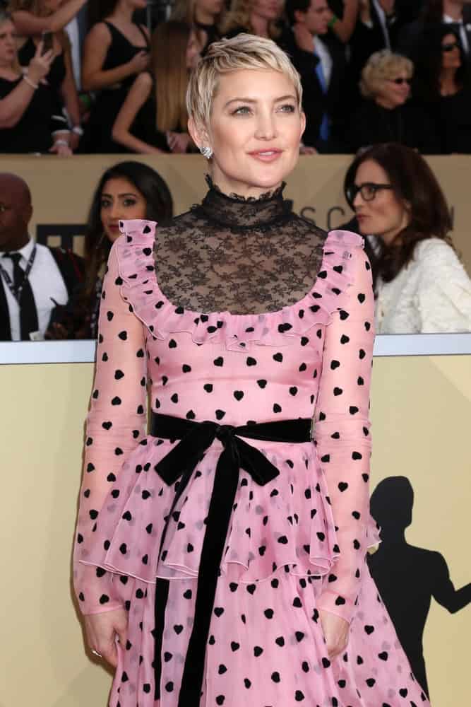 Kate Hudson wowed everyone with her elegant patterned pink dress and highlighted blond pixie hairstyle with short side-swept bangs at the 24th Screen Actors Guild Awards - Press Room at Shrine Auditorium on January 21, 2018 in Los Angeles, CA.