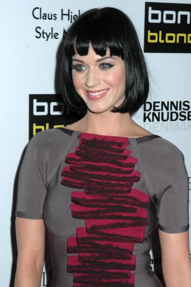 Katy Perry flashed a sweet smile at the Bondi Blonde's Style Mansion on February 9, 2009. She wore an edgy dress along with a bob cut and choppy bangs.