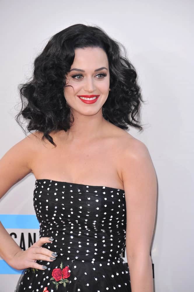 Katy Perry matched her black tube dress with a tousled curly hairstyle during the 2013 American Music Awards at the Nokia Theatre, LA Live on November 24, 2013.