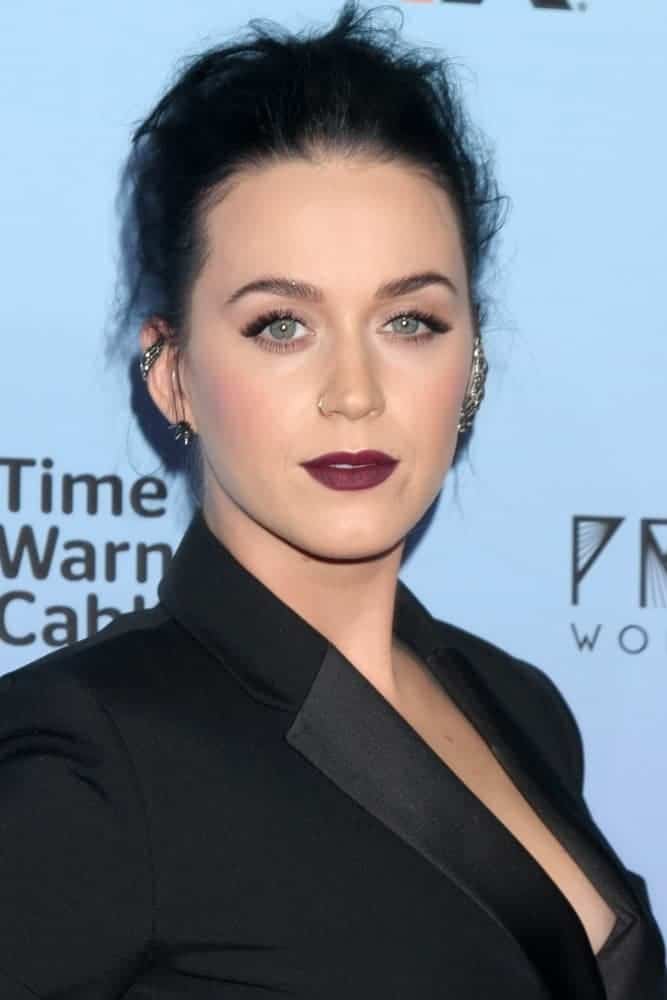 Katy Perry looks sleek in a form-fitting black dress and paired her bold look with a messy upstyle as she attends the Katy Perry: The Prismatic World Tour Premiere.