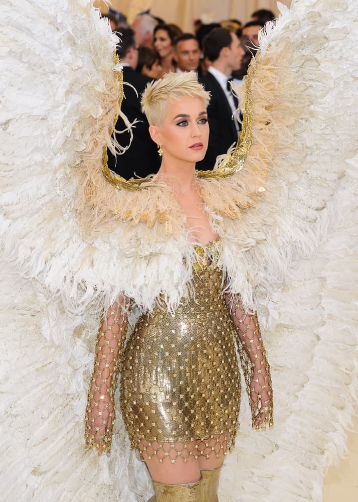 Katy Perry in a gorgeous angel costume along with her feathered pixie cut as she attends the 2018 Metropolitan Museum of Art Costume Institute Benefit Gala on May 7, 2018.