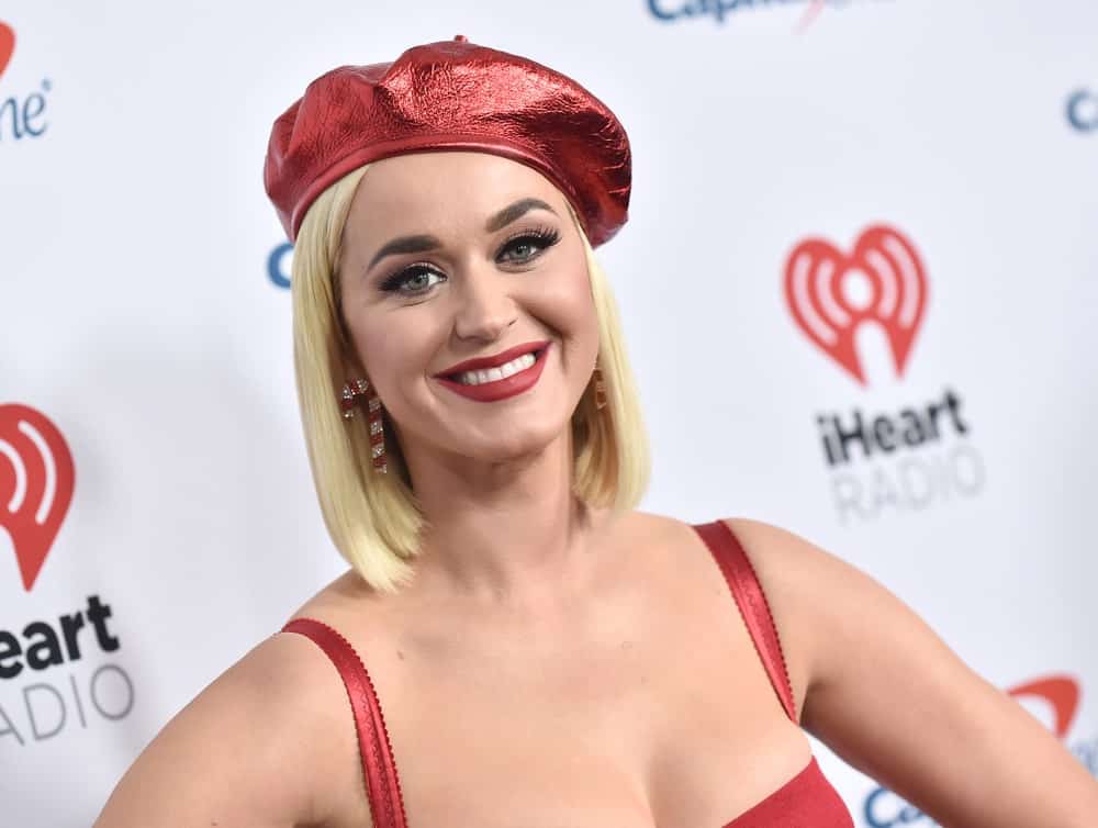 Katy Perry attended the KIIS FM Jingle Ball 2019 on December 6th in Los Angeles, CA rocking her short blonde hair that's complemented with a red newsboy cap.