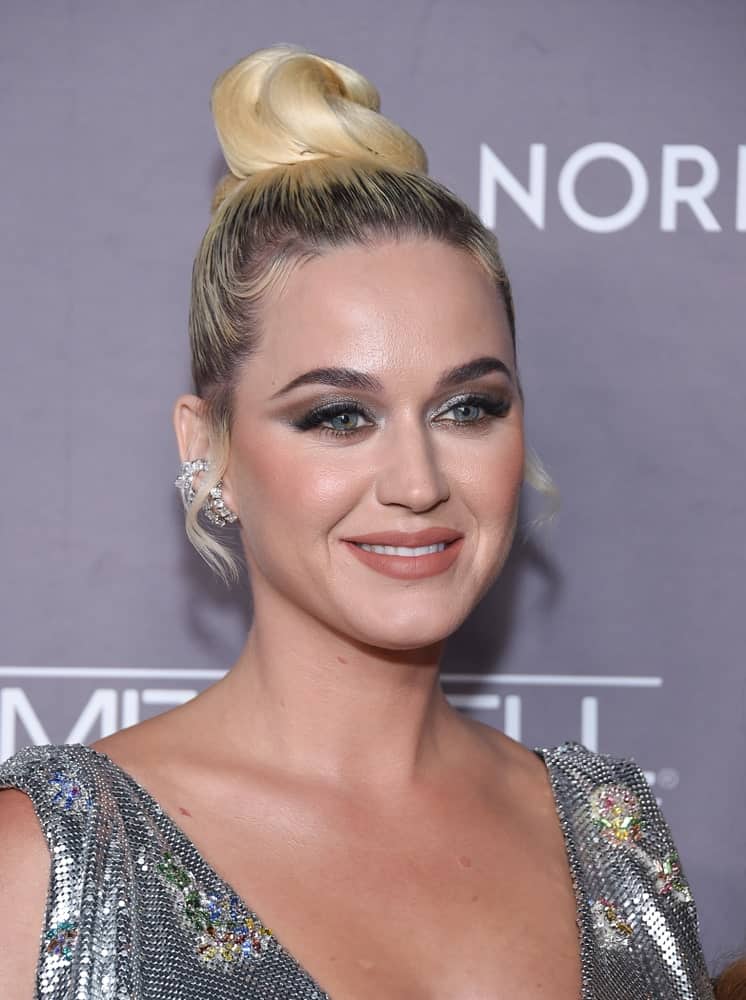 Katy Perry gathered her blonde locks in a stylish top knot with short curly tendrils during the 2019 Baby2Baby Gala Presented by Paul Mitchell on November 09, 2019.