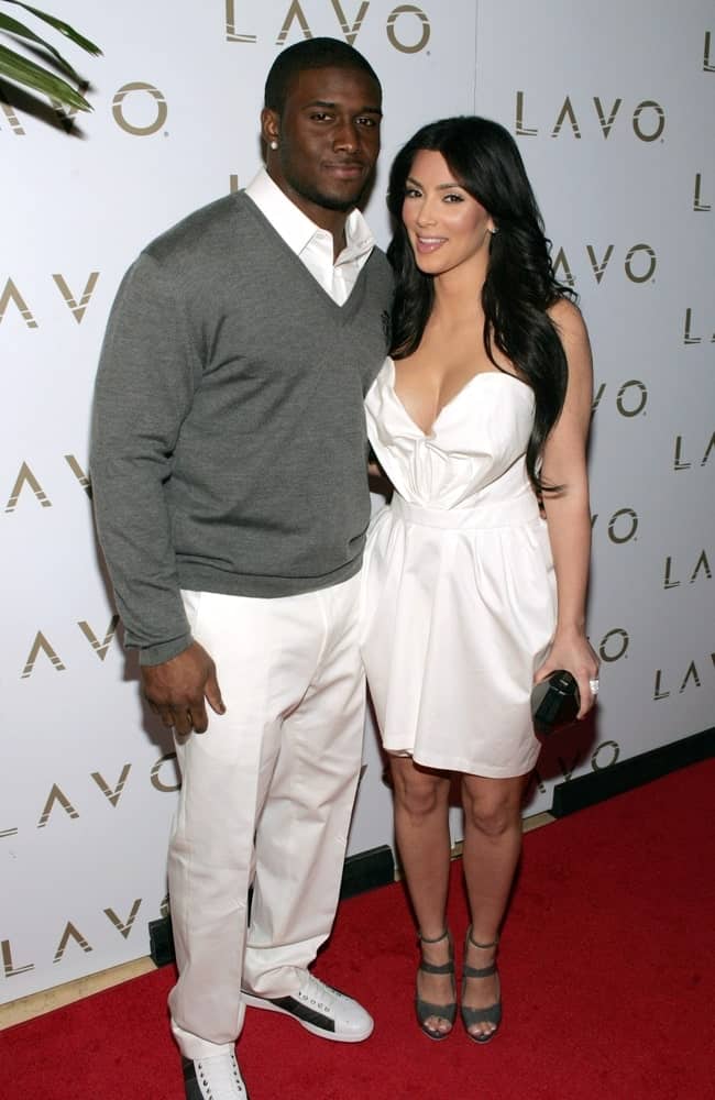 Kim Kardashian with Reggie Bush in attendance for Queen of Hearts Ball at LAVO Restaurant and Nightclub on February 13, 2010. The socialite sported a long wavy hairstyle with a middle parting.