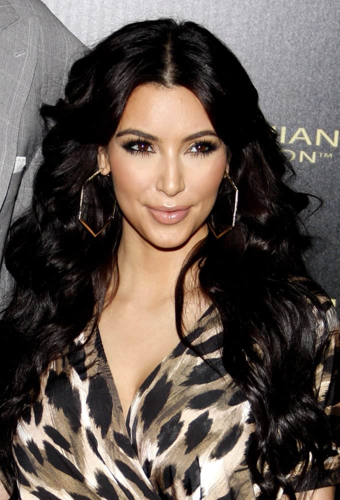 Kim Kardashian paired her printed jumpsuit with voluminous center-parted curls at the Kardashian Kollection Launch Party held at the Colony in Hollywood, USA on August 17, 2011.